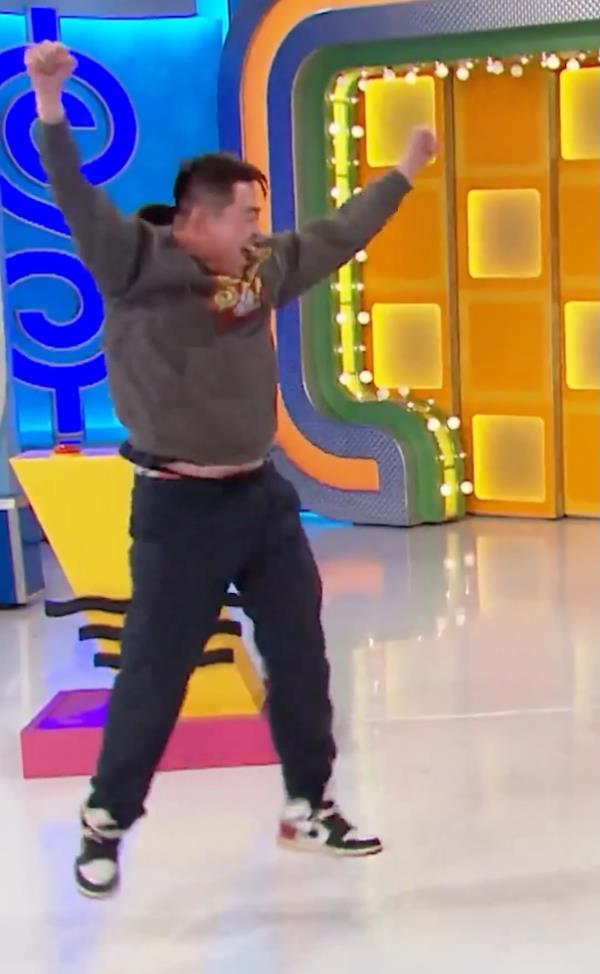Man jumping up and down arms in air.