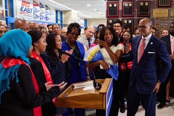 New York City Schools Chancellor David Banks, right, with daughter Aaliyah Banks, received a bouquet of flowers from students after introducing incoming Schools Chancellor Melissa Ramos(in black) during a news co<em></em>nference at the Bronx School for Law, Government and Justice on Wednesday, September 25, 2