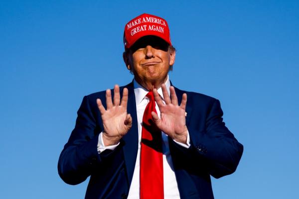 Do<em></em>nald Trump holds his hands up during a rally on May 1, 2024 at Avflight Saginaw in Freeland, Michigan.