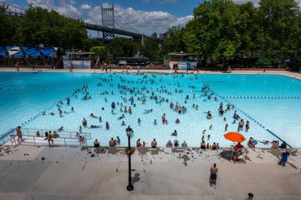 People swim at the Astoria Pool on the opening day of New York City's public swimming pools.