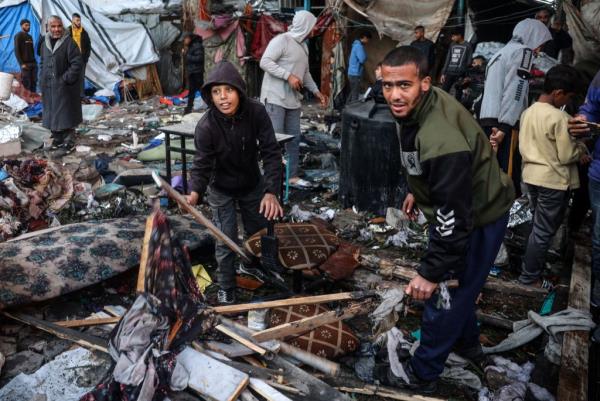 Palestinians sift through rubble.