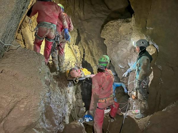 Members of the CNSAS, Italian alpine and speleological rescuers, carry a stretcher with American researcher Mark Dickey during a rescue operation in the Morca cave, near Anamur, southern Turkey, Monday, Sept. 11, 2023. 