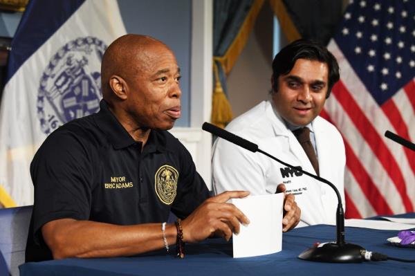 NYC Mayor Eric Adams sits next to health Commissio<em></em>ner Ashwin Vasan in City Hall. 