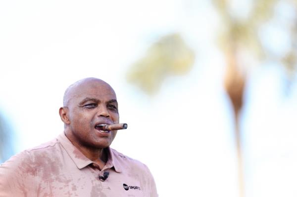 A photo of a sweaty Charles Barkley smoking a cigar,