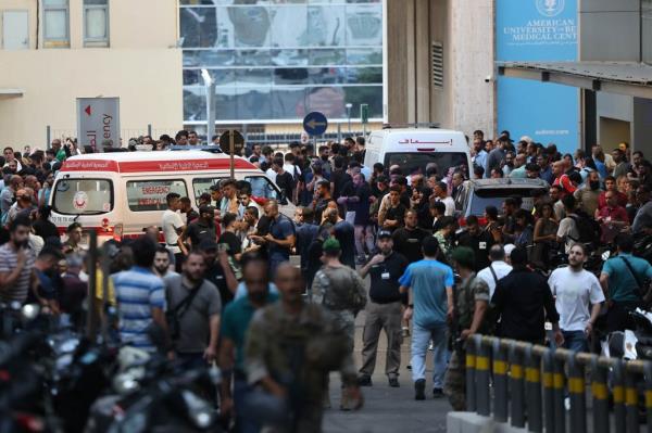Ambulances are surrounded by people at the entrance of the American University of Beirut Medical Center, on September 17, 2024, after explosions hit locations in several Hezbollah stro<em></em>ngholds around Lebanon.