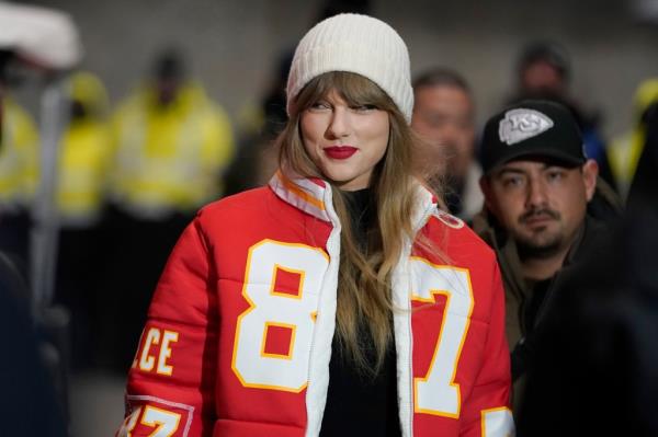 Taylor Swift in a Kansas City Chiefs jacket attends a game. 