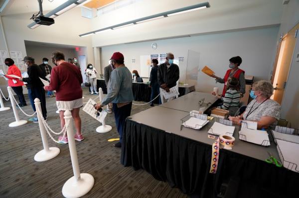 Early voters lining up to cast their ballots at South Regio<em></em>nal Library polling location in Durham, N.C., in October 2020