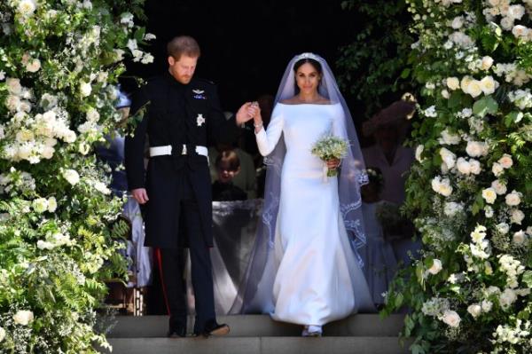 WINDSOR, UNITED KINGDOM - MAY 19: Britain's Prince Harry, Duke of Sussex and his wife Meghan, Duchess of Sussex leave from the West Door of St George's Chapel, Windsor Castle, in Windsor on May 19, 2018 in Windsor, England. (Photo by Ben STANSALL - WPA Pool/Getty Images)