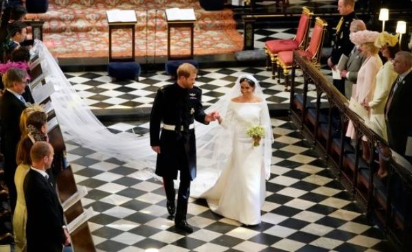 Britain's Prince Harry and Meghan Markle leave after their wedding ceremony at St. George's Chapel in Windsor Castle in Windsor, near London, England, Saturday, May 19, 2018. (Owen Humphreys/pool photo via AP)