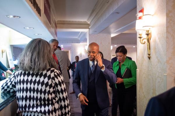 Mayor Eric Adams speaks on a cell phone.