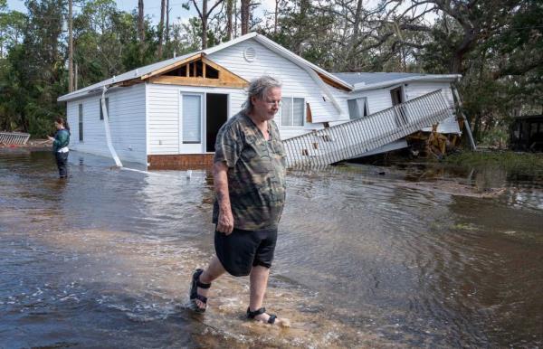 Shane Padgett walks out of his flooded neighborhood wher<em></em>e his home was destroyed by storm surge after Hurricane Helene hit the area.