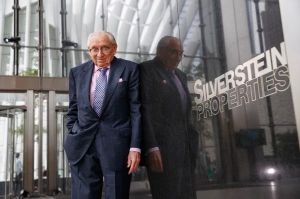 Larry Silverstein standing next to a glass, building exterior wall reading Silverstein Properties