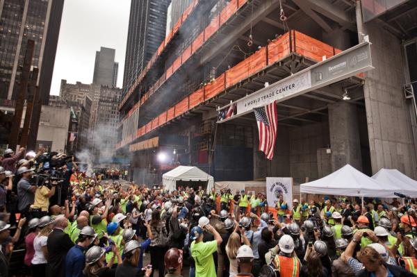 Crowd gathered around an American flag hanging at 4 World Trade center