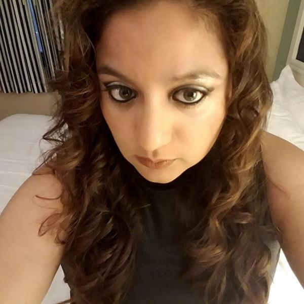 A woman, Sandy Carazas-Pinez, former DOE biology teacher, taking a selfie