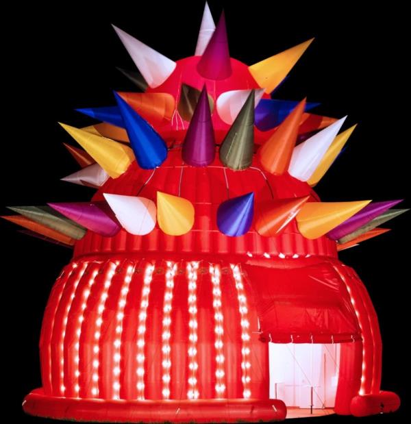 A red tent at Luna Luna created by André Heller, the park's creator, features multicolored spikes on top of its bulbous main section.