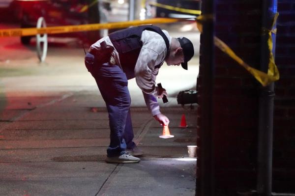 Police at the scene wher<em></em>e two people were shot near a smoke shop