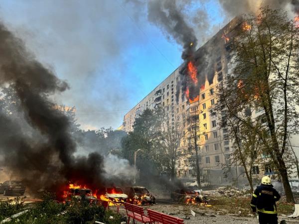 Civilian building burns after Russian strike.