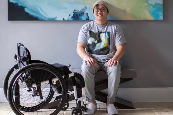 Pictured: Sean Chang at home with his wheelchair.