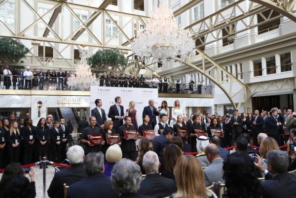 Do<em></em>nald Trump, together with his family, from left, Do<em></em>nald Trump Jr., Eric Trump, Trump, Melania Trump, Tiffany Trump and Ivanka Trump, speaks in the hotel lobby, during the grand opening of Trump Internatio<em></em>nal Hotel in Washington, Wednesday, Oct. 26, 2016.