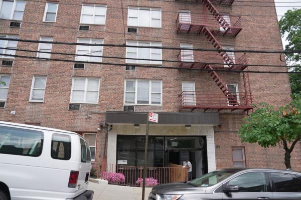 Workers move items into a migrant center that will be opening soon at 435 West 238th Street. 