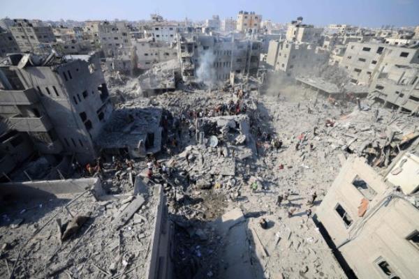 People check the rubble of buildings destroyed in an Israeli strike on the Bureij refugee camp in the central Gaza Strip on November 2, 2023, as battles between Israel and the Palestinian Hamas movement continue. (Photo by MAHMUD HAMS / AFP) (Photo by MAHMUD HAMS/AFP via Getty Images)