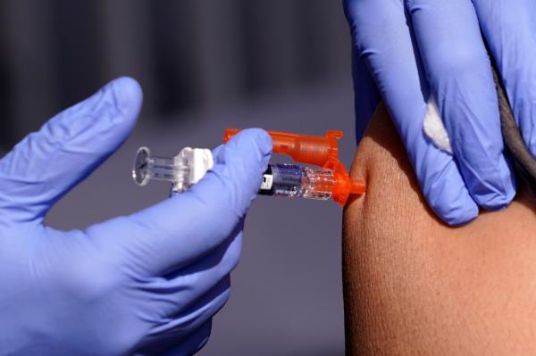 A patient is given a flu vaccine.
