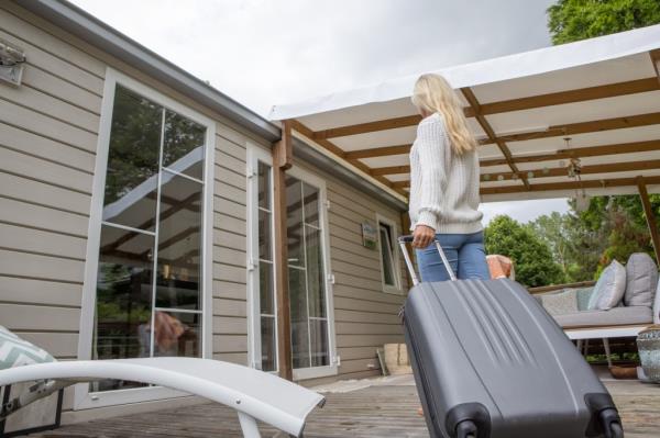 A woman walking with luggage. 
