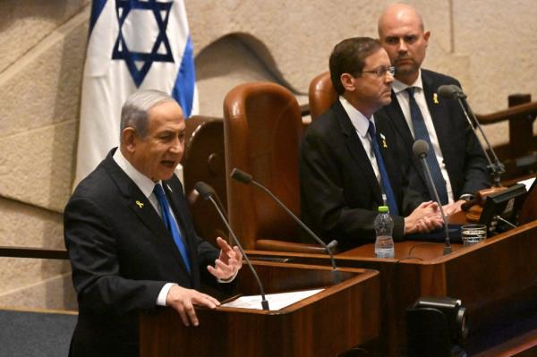 Israeli Prime Minister Benjamin Netanyahu speaking at the opening of the 25th Parliament session in Jerusalem, with Alastair Stewart, Amir Ohana, Isaac Herzog at podiums with microphones.