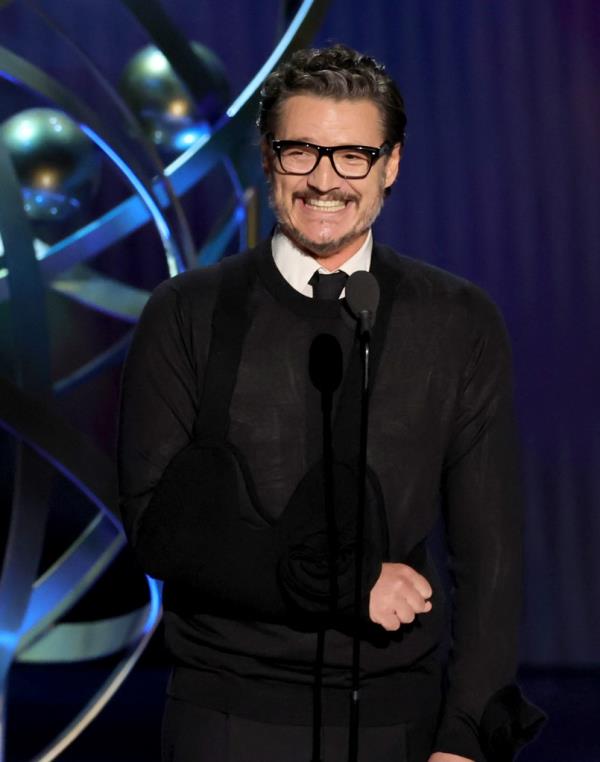 Pedro Pascal smiling onstage. 