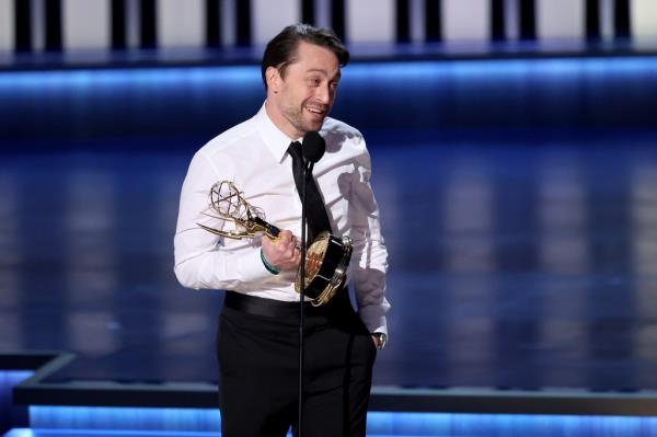 Kieran Culkin holding his Emmy. 