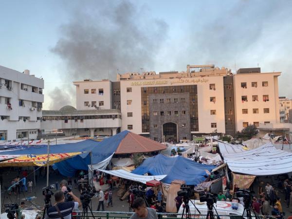 Smoke rises as displaced Palestinians take shelter at Al-Shifa hospital earlier this week.