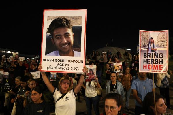 Relatives and supporters raise placards bearing portraits of Israeli hostage Hersh Goldberg-Polin