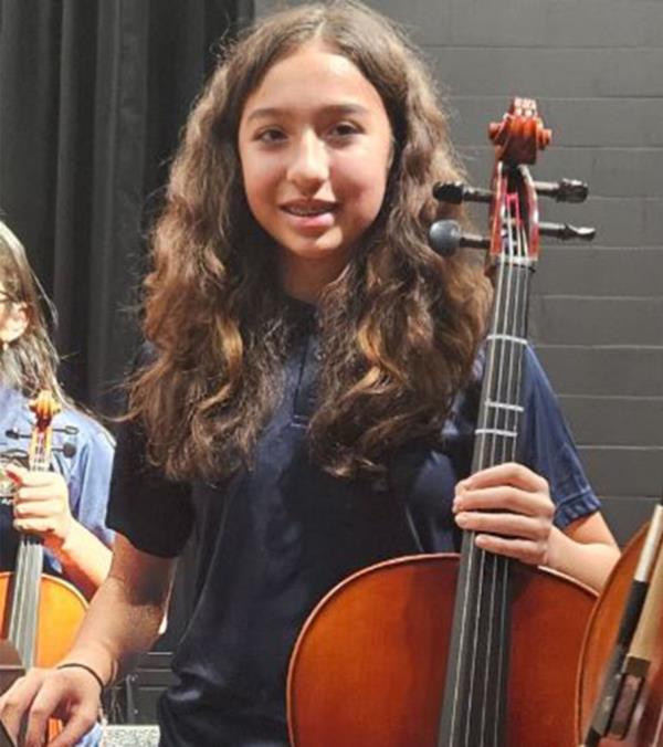 Jocelyn Nungaray is seen in a photo wher<em></em>e she is holding a cello and smiling.