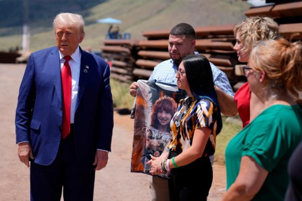 Republican presidential nominee former President Do<em></em>nald Trump speaks during a tour of the southern border with Mexico, Thursday, Aug. 22, 2024, in Sierra Vista, Ariz, as Alexis Nungaray, mother of Jocelyn, listens as Joamel Guevara holds a shirt with a photo of Jocelyn.