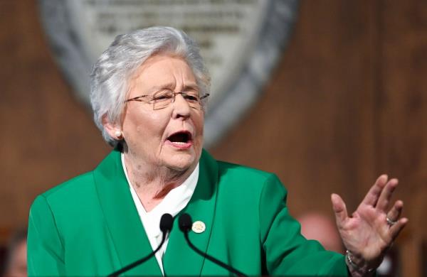 Alabama Gov. Kay Ivey, in a green jacket.