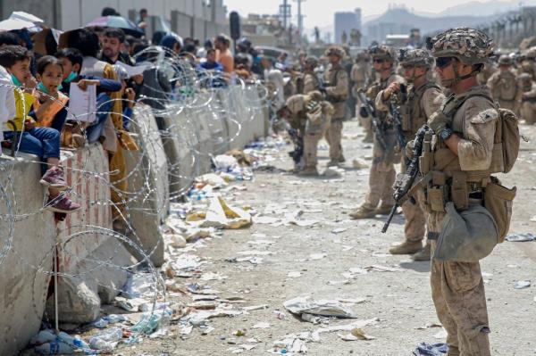 U.S. Marines with Special Purpose Marine Air-Ground Task Force - Crisis Respo<em></em>nse - Central Command, provide assistance during an evacuation at Hamid Karzai Internatio<em></em>nal Airport in Kabul, Afghanistan, Aug. 20, 2021.