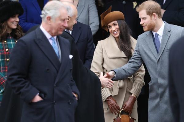 King Charles talks to Prince Harry and Meghan Markle.