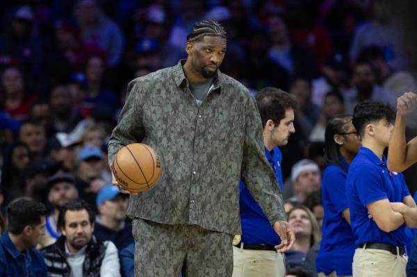 Injured Philadelphia 76ers center Joel Embiid dribbles the ball during a timeout in the second quarter against the LA Clippers at Wells Fargo Center on March 27, 2024. 