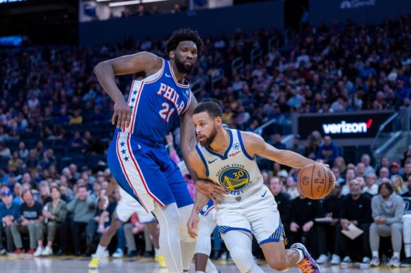 Golden State Warriors guard Stephen Curry (30) drives against Philadelphia 76ers center Joel Embiid (21) during the fourth quarter at Chase Center on January 30, 2024. 