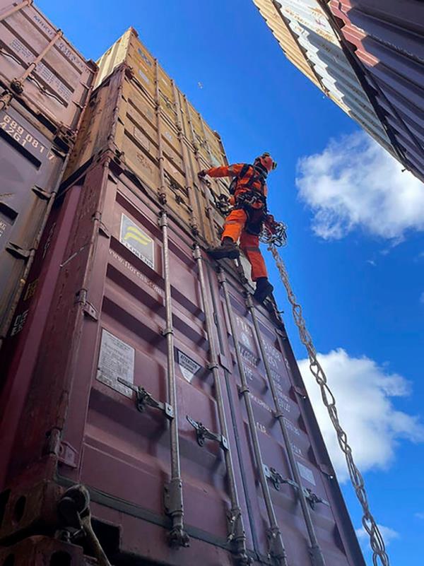 A specialized salvage climber scales a co<em></em>ntainer to survey the damage to co<em></em>ntainers o<em></em>nboard the cargo ship Dali at the site of the Francis Scott Key Bridge on April 6, 2024, in Baltimore. 