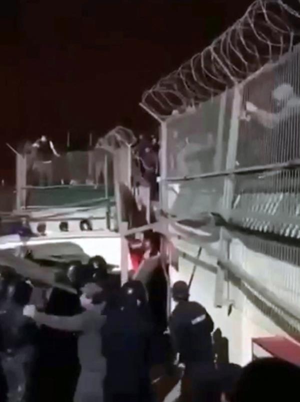 Law enforcement perso<em></em>nnel prevent protesters from breaking info the fence of an airport in Makhachkala on Oct. 29, 2023.