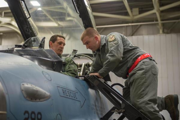 Air Force Staff Sgt. Robert Knickle, right, helps Lt. Col. Mark Sletten into an F-16 Fighting Falcon fighter aircraft on Eielson Air Force ba<em></em>se, Alaska, Dec. 7, 2015.