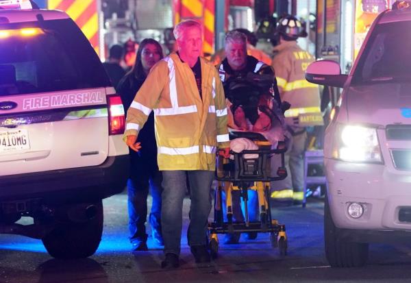 A man is seen being transported by emergency perso<em></em>nnel following the explosion.
