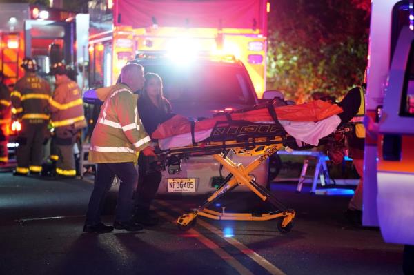 A rescue worker is seen rolling a stretcher at the scene of the explosion.