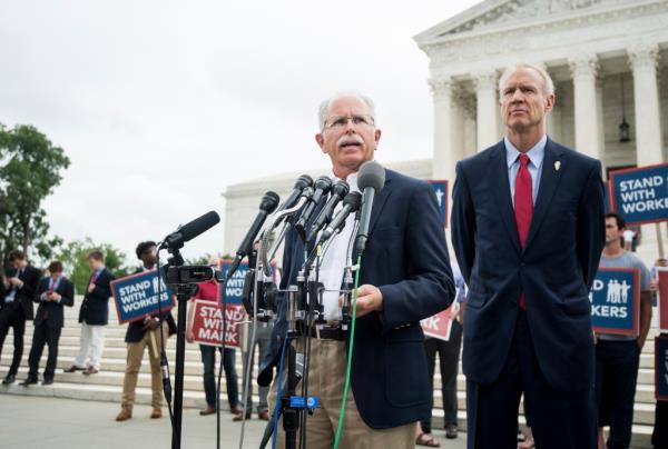 Illinois state employee Mark Janus (left) speaking outside of the Supreme Court building after the court ruled in his favor for the case Janus v. AFSCME on June 27, 2018.