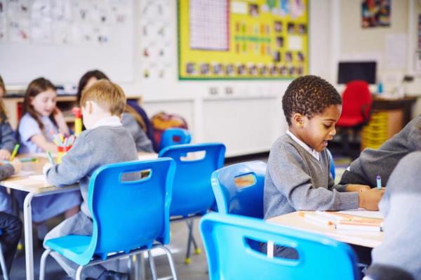Children drawing at desks