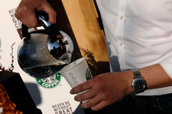 Man pouring coffee from coffeepot at Starbucks on Feb. 18, 2009.