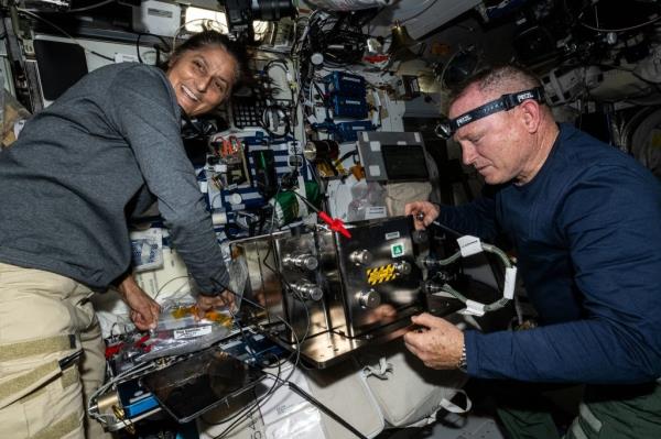 Butch Wilmore and Suni Williams preparing hardware in space station