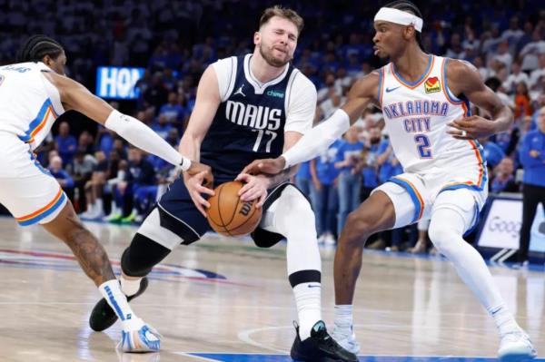 Luka Doncic, who was held to 19 points, has the ball stripped as he drives between Shai Gilgeous-Alexander (right) and Jalen Williams during the Thunder's 117-95 Game 1 win over the Mavericks. 
