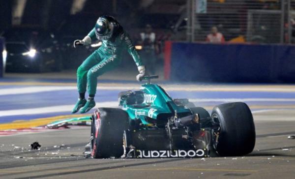 Lance Stroll climbs out of his Aston Martin after crashing in qualifying 